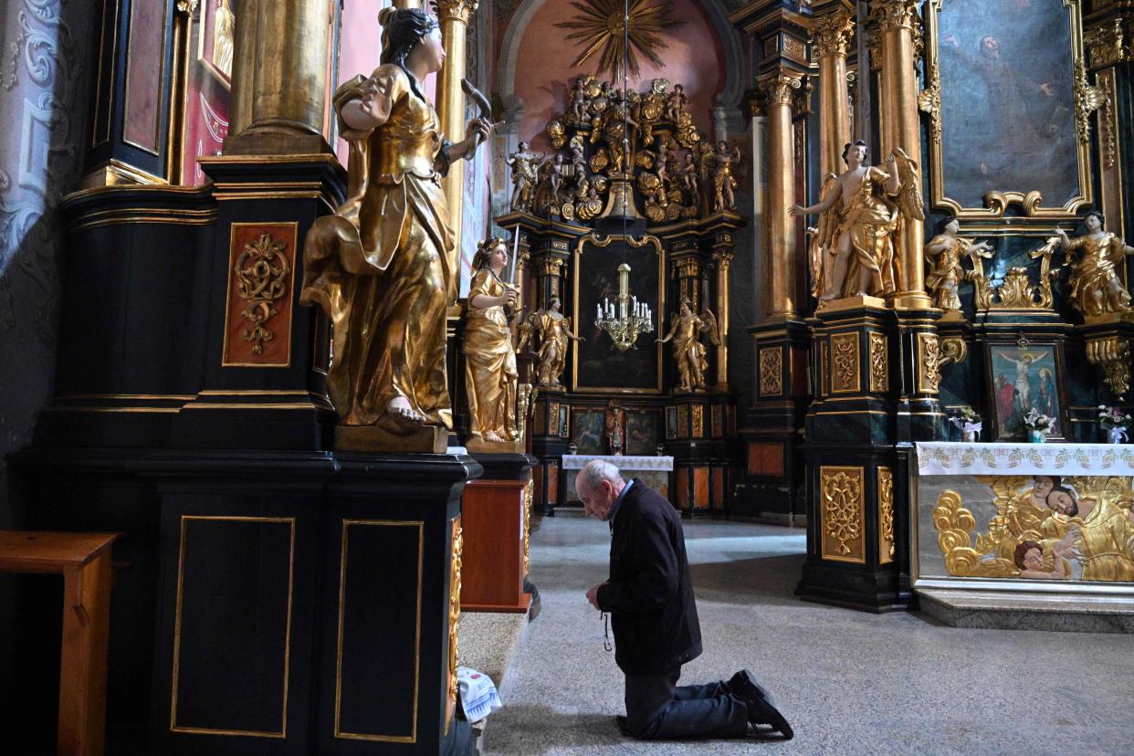 A man prays during a service at Saint Andrew Church on the eve of Orthodox Easter in western Ukrainian city of Lviv (AFP via Getty Images)