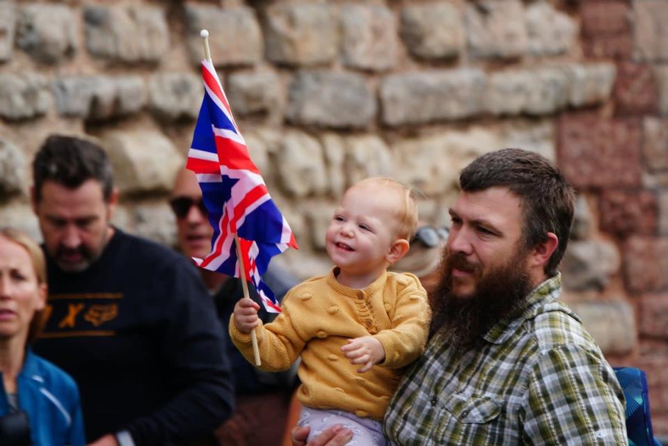 A small child holds a union flag ahead of the proclamation ceremony (Ben Birchall/PA) (PA Wire)