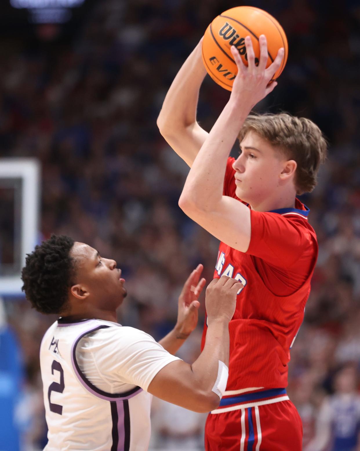 Kansas guard Johnny Furphy (10) looks for a pass over Kansas State guard Tylor Perry (2) in the first half of the Sunflower Showdown inside Allen Fieldhouse on March 5, 2024.