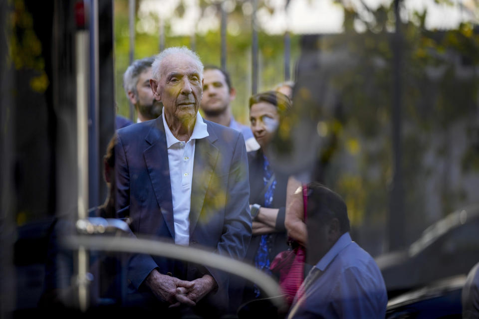 Emanuele Di Porto, 92, is seen through the doors of a bus of the No. 23 route during the inaugurating of a traveling exhibit recounting his story, in Rome, Tuesday, Oct. 10, 2023. Di Porto, at the time a 12 years old Roman Jew, hid on a tram for a few days from Nazi deportation in October 1943, with drivers feeding him and helping him.The traveling exhibit is a highlight of events commemorating the 80th anniversary of the roundup of some 1,200 of the city's tiny Jewish community by German soldiers during the Nazi occupation in the latter years of World War II. (AP Photo/Andrew Medichini)
