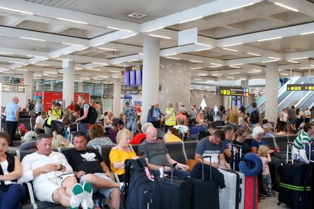 Passengers are seen at Mallorca Airport after Thomas Cook, the world's oldest travel firm collapsed, in Palma de Mallorca