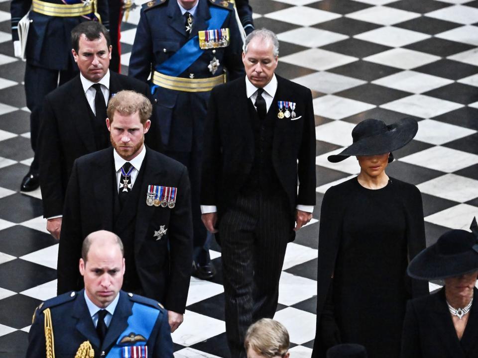 Prince Harry and Meghan Markle exit the Queen's funeral at Westminster Abbey.