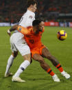 France's Benjamin Pavard, left, and Netherlands' Memphis Depay vie for the ball during the international friendly soccer match between The Netherlands and France at De Kuip stadium in Rotterdam, Netherlands, Friday, Nov. 16, 2018. (AP Photo/Peter Dejong)