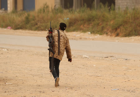 A member of the Libyan internationally recognised government walks during the fighting with the Eastern forces in Ain Zara, in Tripoli, Libya April 21, 2019. REUTERS/Ahmed Jadallah