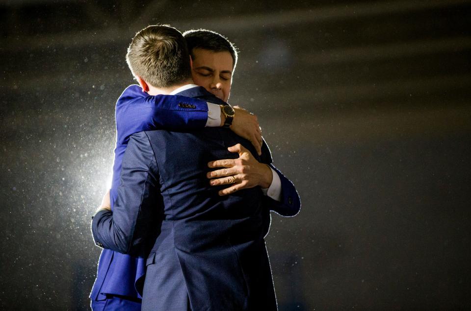 Former South Bend Mayor Pete Buttigieg hugs his husband, Chasten, at his Iowa caucus watch party at Drake University in Des Moines. Delays and errors marred the 2020 caucus count. The final tally, still with evident errors, shows Buttigieg edged U.S. Sen. Bernie Sanders of Vermont by a whisker.