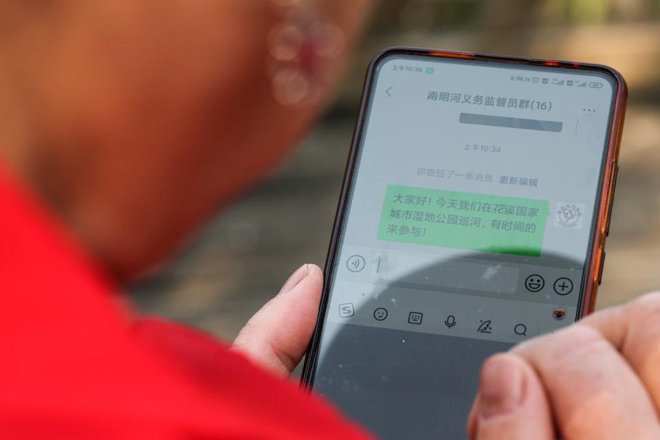 A smartphone displays WeChat’s group-messaging function. <a href="https://www.gettyimages.com/detail/news-photo/environmental-protection-volunteer-zhou-yuqing-organizes-a-news-photo/1244511282" rel="nofollow noopener" target="_blank" data-ylk="slk:Ou Dongqu/Xinhua via Getty Images;elm:context_link;itc:0;sec:content-canvas" class="link ">Ou Dongqu/Xinhua via Getty Images</a>