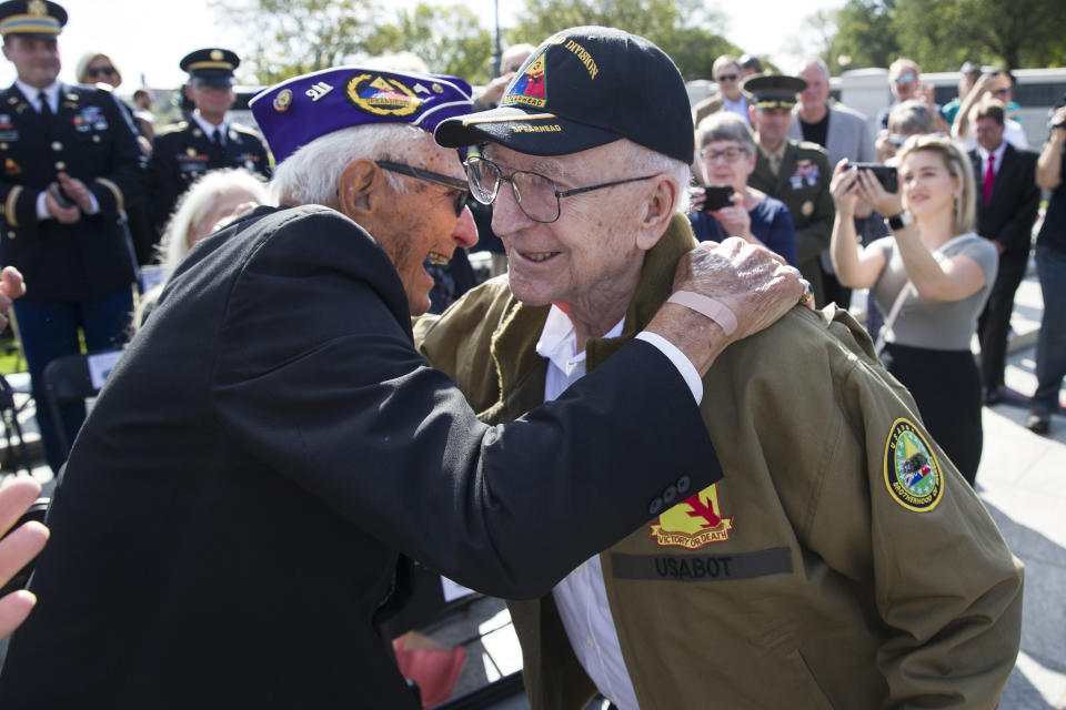 World War II veterans Joseph Caserta, left, and Clarence Smoyer, 96, embrace before a ceremony to present the Bronze Star to Smoyer at the World War II Memorial, Wednesday, Sept. 18, 2019, in Washington. Smoyer fought with the U.S. Army's 3rd Armored Division, nicknamed the Spearhead Division. In 1945, he defeated a German Panther tank near the cathedral in Cologne, Germany — a dramatic duel filmed by an Army cameraman that was seen all over the world. (AP Photo/Alex Brandon)