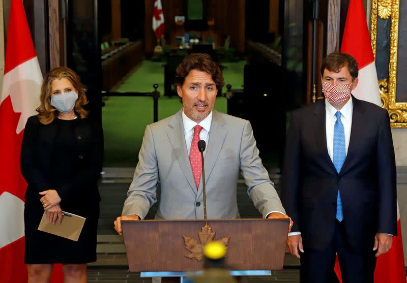 FILE PHOTO: Canadian Prime Minister Trudeau speaks to reporters next to Canadian Deputy Prime Minister and Finance Minister Freeland and Minister of Intergovernmental Affairs LeBlanc on Parliament Hill in Ottawa
