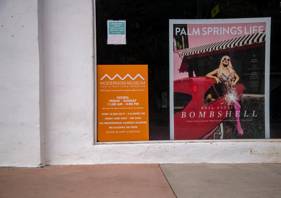 Signs are seen in the window for the former Modernism Museum in Palm Springs this week.