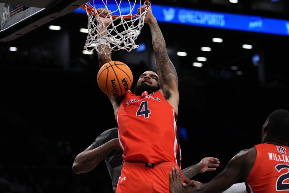 Auburn's Johni Broome dunks against St. Bonaventure during the second half of an NCAA college basketball game in the final of the Legends Classic tournament Friday, Nov. 17, 2023, in New York. (AP Photo/Frank Franklin II)