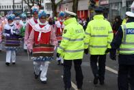 <p>German police walk past dressed-up people during a carnival parade on Rose Monday on Feb. 12, 2018 in Duesseldorf, western Germany. (Photo: Patrik Stollarz/Getty Images) </p>