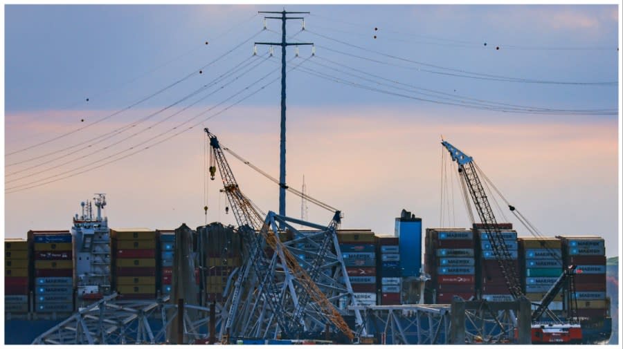 Workers start to remove a section of the collapsed Francis Scott Key Bridge March 31, 2024, in Baltimore.