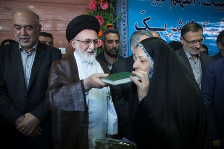 An Iranian pilgrim kisses the Koran as she departs for the annual haj pilgrimage to the holy city of Mecca, at the Imam Khomeini Airport in Tehran, Iran, July 31, 2017. Nazanin Tabatabaee Yazdi/TIMA via REUTERS.