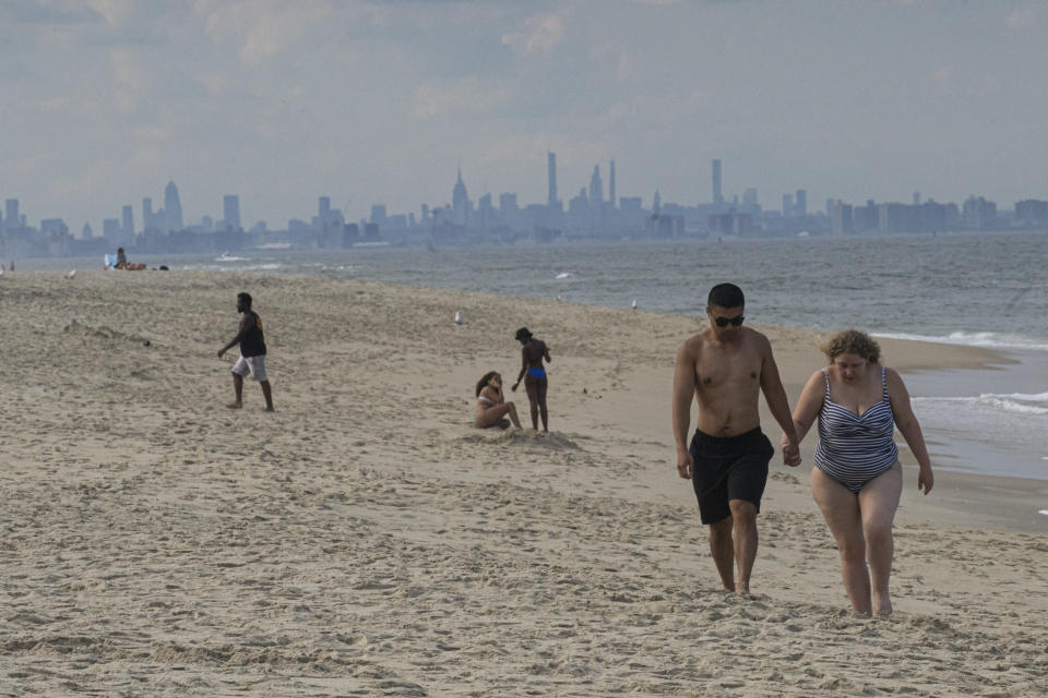 People visit the beach of Sandy Hook in front of the Manhattan skyline on June 26, 2020, in Sandy Hook, New Jersey. (Photo: Kena Betancur/VIEWpress/Corbis via Getty Images)