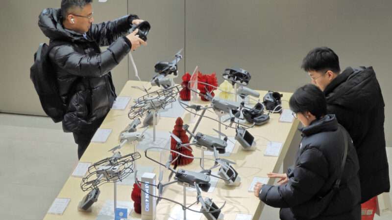 Customers learn about drone products at a DJI experience store in Yantai, East China s Shandong province, Jan 31, 2024.