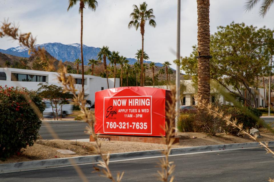 Enzo's Bistro and Bar displays a "now hiring" sign toward Highway 111 outside the restaurant in Rancho Mirage, Calif., on Jan. 12, 2022. The location has been unable to reopen due to a lack of the roughly 60 workers needed. 