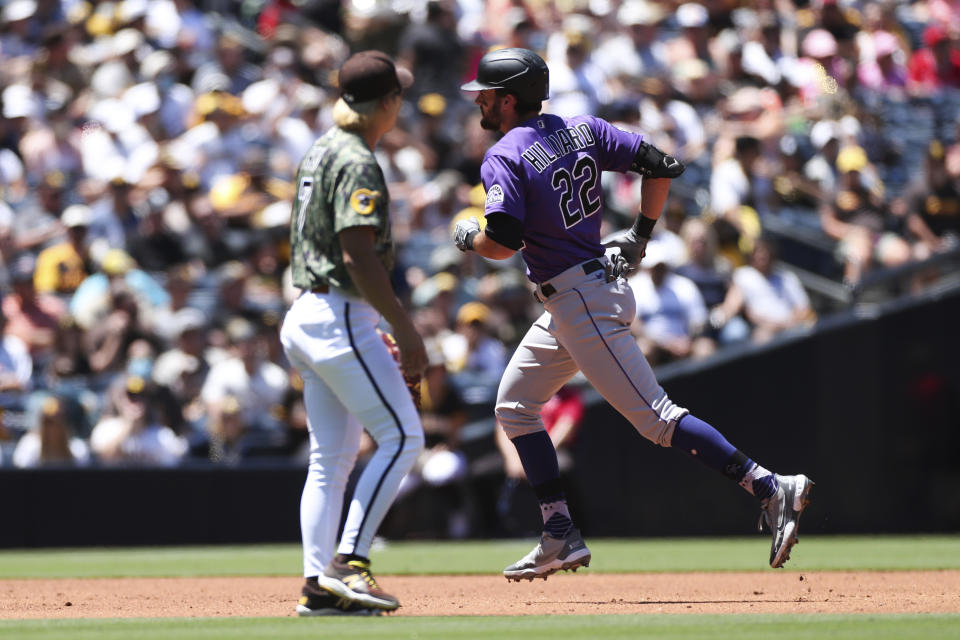 Colorado Rockies' Sam Hilliard, right, runs the bases after hitting a home run as San Diego Padres shortstop Ha-Seong Kim looks on in the second inning of a baseball game Sunday, Aug. 1, 2021, in San Diego. (AP Photo/Derrick Tuskan)