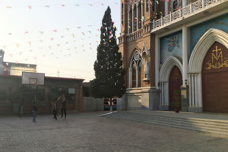 Teenagers play basketball at the compound of Our Lady of China Catholic Church in Donglu village, Hebei province, China October 3, 2018. Picture taken October 3, 2018. REUTERS/Christian Shepherd