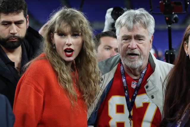 <p>Patrick Smith/Getty </p> Taylor Swift walks off the field with Ed