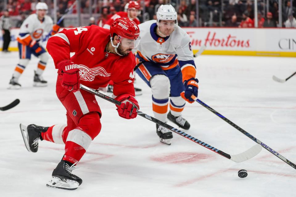 Red Wings center Robby Fabbri makes a pass against Islanders defenseman Ryan Pulock during the third period of the Wings' 5-3 loss on Thursday, Feb. 29, 2024, at Little Caesars Arena.