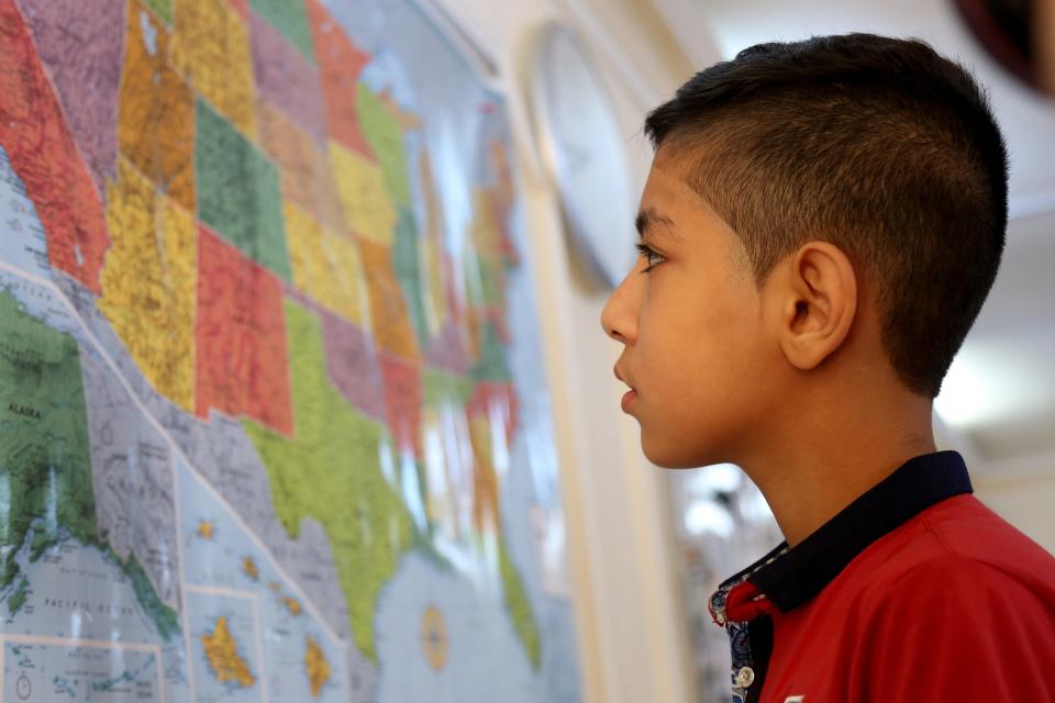 Syrian refugee Hamzeh Jouriyeh, 12, studies a map of the USA in the Amman, Jordan, office of the International Organization for Migration. Jouriyeh, his three siblings and his parents were headed to San Diego as part of a yearlong program in 2016 to resettle 10,000 Syrian refugees in the USA.