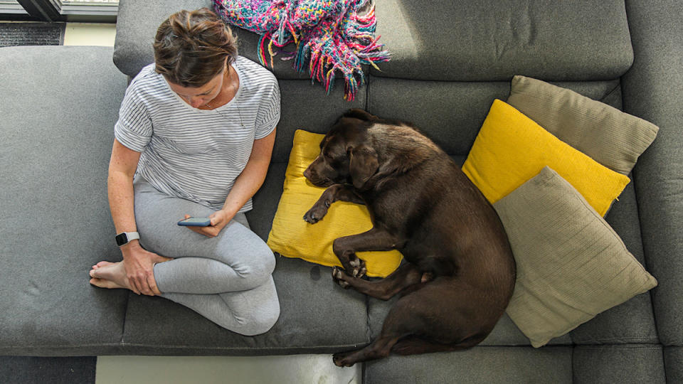 woman sitting with a dog on the couch with no pee smells on couch