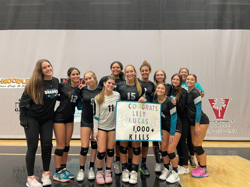 Gulf Coast hitter Lily Lucas is surrounded by her teammates after being recognized for eclipsing 1,000 kills following Tuesday’s district semifinal against Sarasota Riverview.
