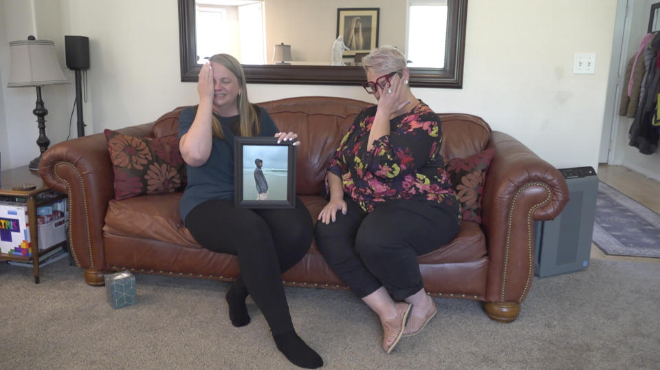 Rebecca Higbee, left, the mother of Tyler Thompson, and Miranda Thompson, the stepmother, tear up during an interview Thursday, May 30, 2024, in West Jordan, Utah. A Utah family whose son has been implicated in a thwarted coup in Congo says they're unsure if he is still alive. U.S. officials have struggled to make contact with Tyler Thompson and two other Americans two weeks after their arrest. (AP Photo/Rick Bowmer)