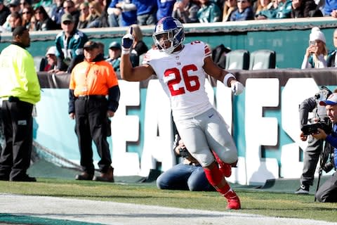 New York Giants running back Saquon Barkley celebrates a touchdown during the first half of an NFL football game against the Philadelphia Eagles - Credit: AP Photo/Chris Szagola