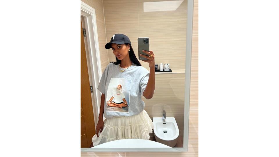 Maya Jama takes a mirror selfie in a mini skirt and graphic tee