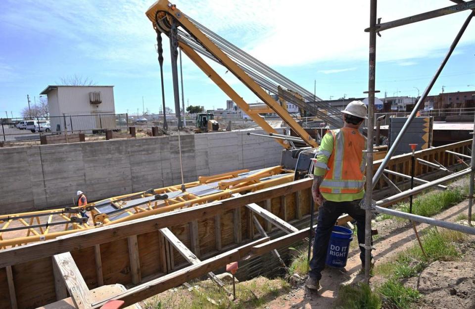 A worker steps around scaffolding at the Tulare Street underpass construction site during a tour of High Speed Rail development Friday. March 22, 2024 in downtown Fresno. ERIC PAUL ZAMORA/ezamora@fresnobee.com