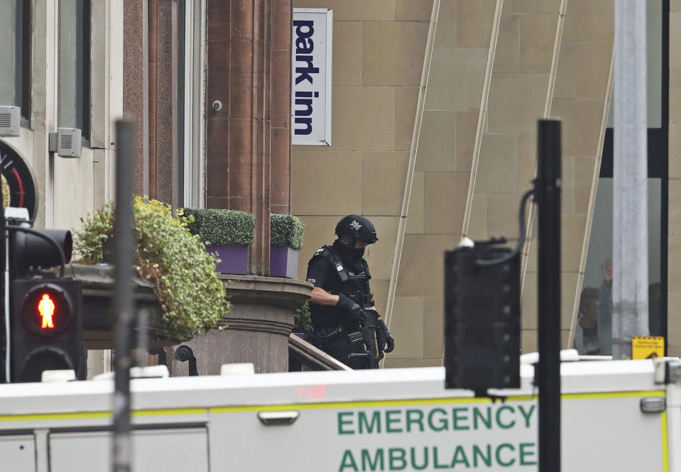 Armed police at the scene of an incident in Glasgow, Scotland, Friday June 26, 2020. Police in Glasgow say emergency services are currently dealing with an incident in the center of Scotland's largest city and are urging people to avoid the area. (Andrew Milligan/PA via AP)