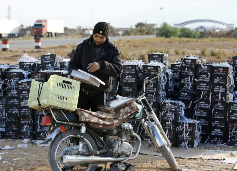 Bahaa al-Masri sells date-filled pastries and sesame biscuits to Jordanians at the recently reopened Nassib border post in Daraa, south of Damascus