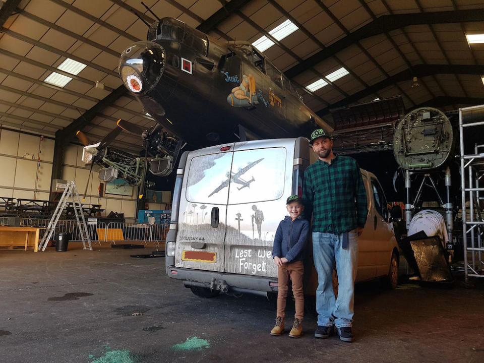 The mural’s creator, Shaun Harvey, with his son, Zak, with the van parked underneath a Lancaster Bomber at Lincolnshire Aviation Heritage Centre (Picture: PA)