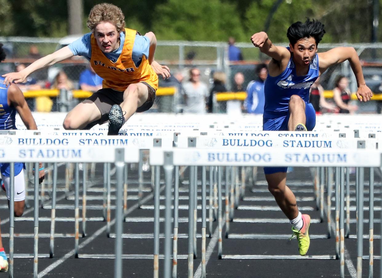 North Kitsap's Carter Braund (left) and Olympic's Jesiah Guadiz-Macadangdang compete in the 100 hurdles during the West Central District III 1A and 2A Track and Field Championships at North Mason High School in Belfair on Friday, May 20, 2022. 