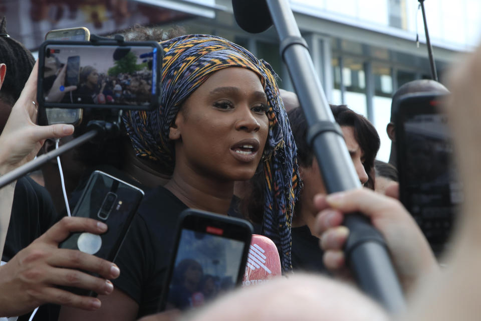 Assa Traore, sister of Adama Traore, answers reporters outside the Palace of Justice Tuesday, June 2, 2020 in Paris. French authorities banned the protest over racial injustice and heavy-handed police tactics as global outrage over what happened to George Floyd in the United States kindled frustrations across borders and continents. Family and friends of Adama Traore, a French black man who died shortly after he was arrested by police in 2016, call for a protest which will also pay homage to George Floyd. (AP Photo/Michel Euler)