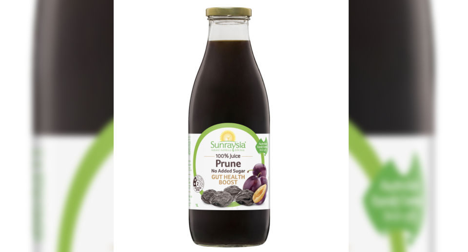 The Woolworths and Coles recall of Sunraysia Prune Juice bottle. It has a white and green label with images of plums on it. 