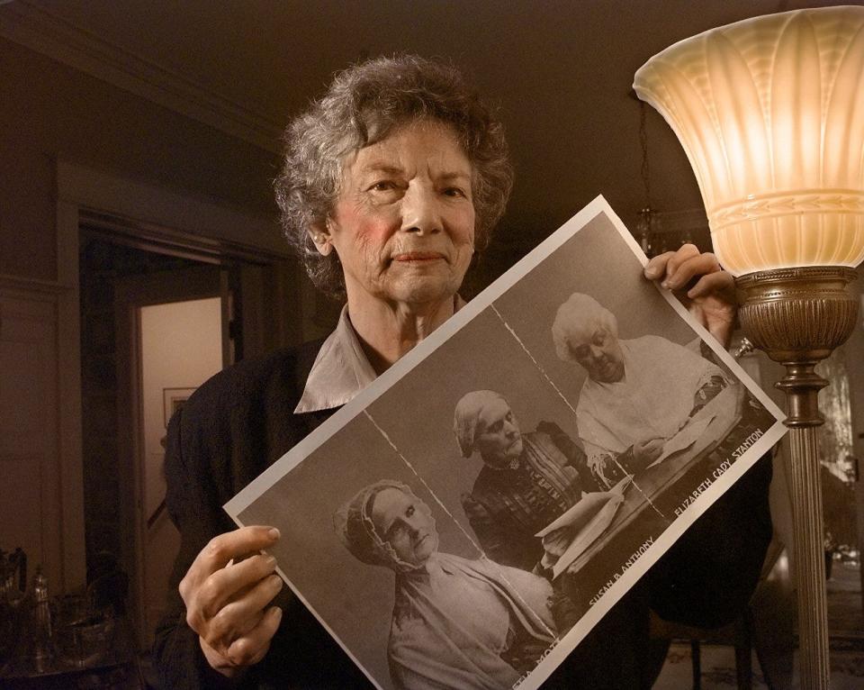 Nan Johnson in 1998 with photographs of Lucretia Mott, Susan B. Anthony and Elizabeth Cady Stanton.