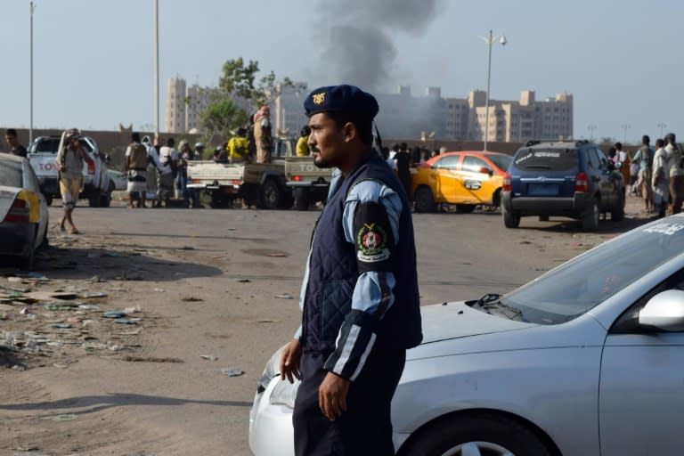 Yemeni security forces patrol after Sheikh bin Farid palace (in the background), used as a base by the Saudi-led coalition forces, was hit by a rocket attack on October 6, 2015 on the outskirts of the southern city of Aden