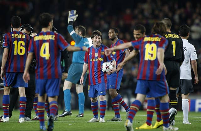 Lionel Messi holds the match ball after his star showing against Arsenal