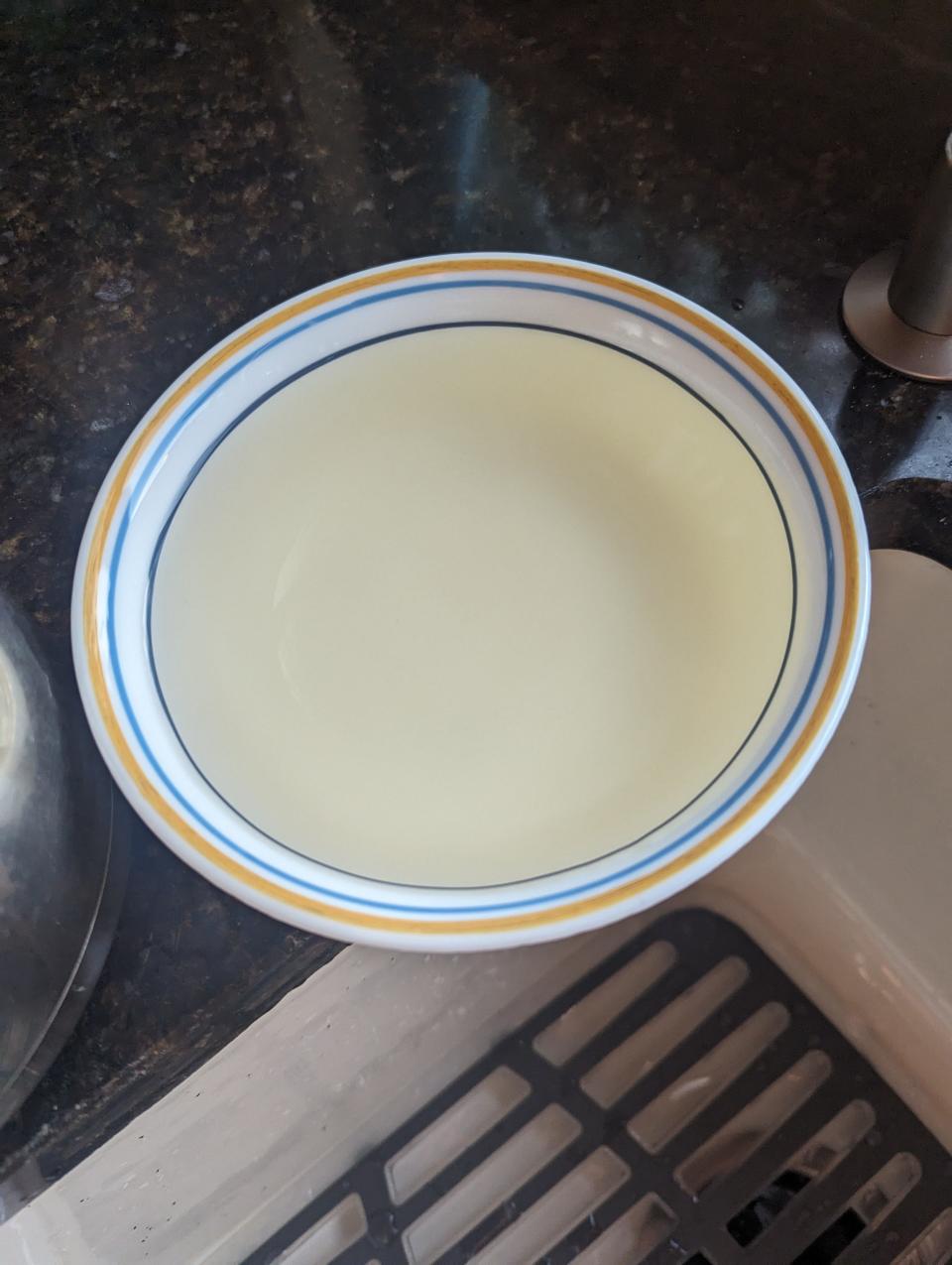 Eckelaert took a photo of his kitchen sink water in a white bowl in order to show the water's discoloration in August 2023.