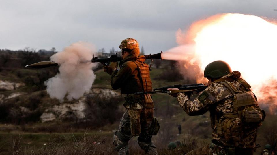 New Ukrainian army brigade recruits take part in a military exercise conducted by a foreign instructor