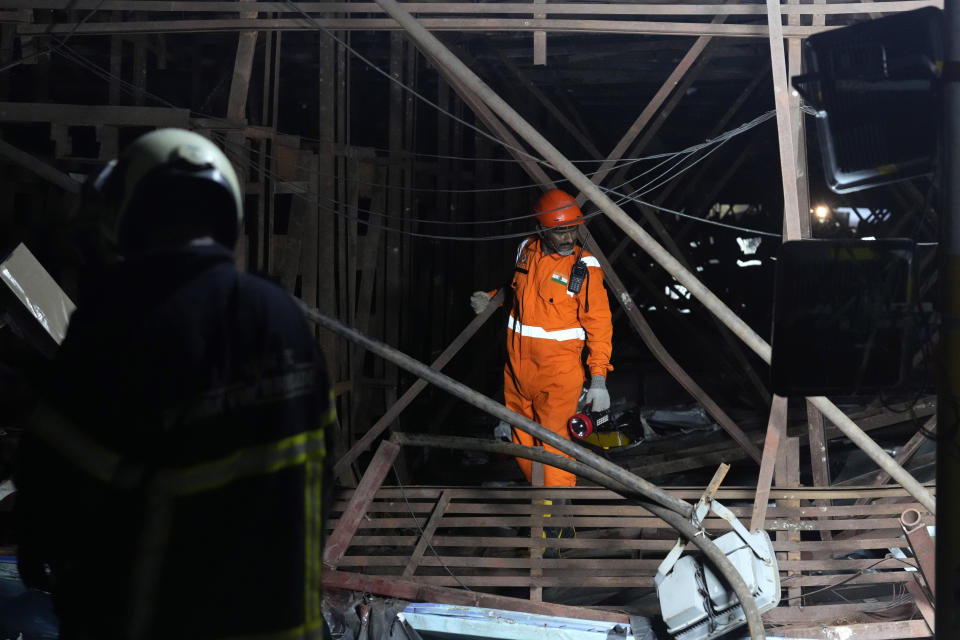 Rescuers look for victims under a billboard that collapsed following heavy rain and thundershowers in Mumbai, India, Monday, May 13, 2024. Scores of people were thought to be trapped after the collapse in the suburb of Ghatkopar, Mumbai police said on social media platform X. (AP Photo/Rafiq Maqbool)