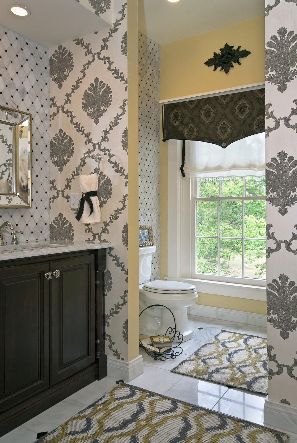 A warm, butter-gold hue complements the patterned wallpaper.