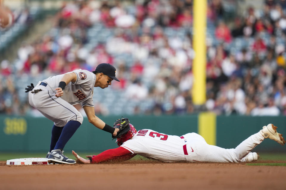 Los Angeles Angels' Taylor Ward (3) is caught stealing second by Houston Astros second baseman Mauricio Dubon (14) during the first inning of a baseball game in Anaheim, Calif., Monday, May 8, 2023. (AP Photo/Ashley Landis)