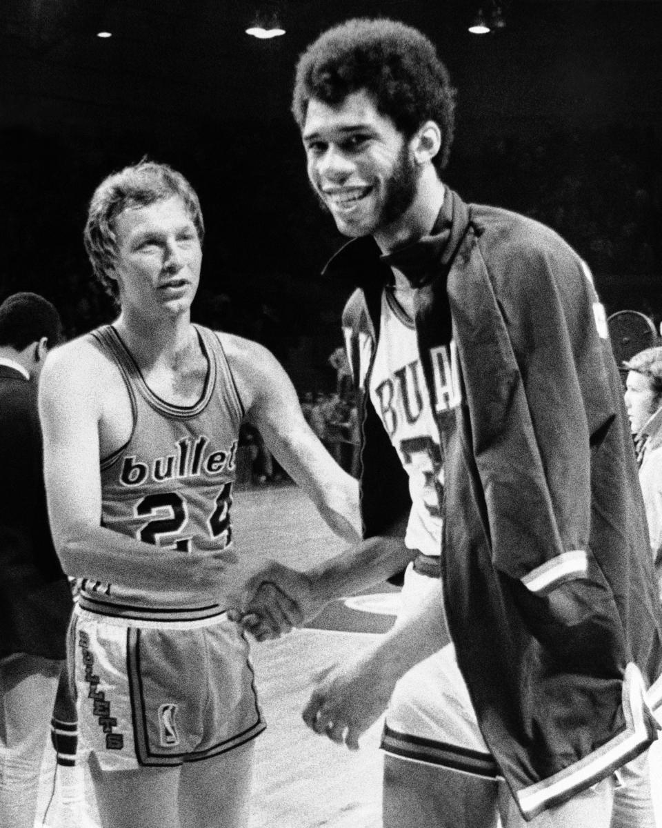 Lew Alcindor, later renamed Kareem Abdul Jabbar, smiles as he receives congratulations from Baltimore Bullets' Jack Marin (24) after winning the NBA championship in Milwaukee in 1971. The Bucks' first season wasn’t all that dazzling at 27-55 in 1968-69. But then they drafted Alcindor with the No. 1 pick. In 1970-71, the Bucks captured an NBA title by sweeping the Baltimore Bullets.