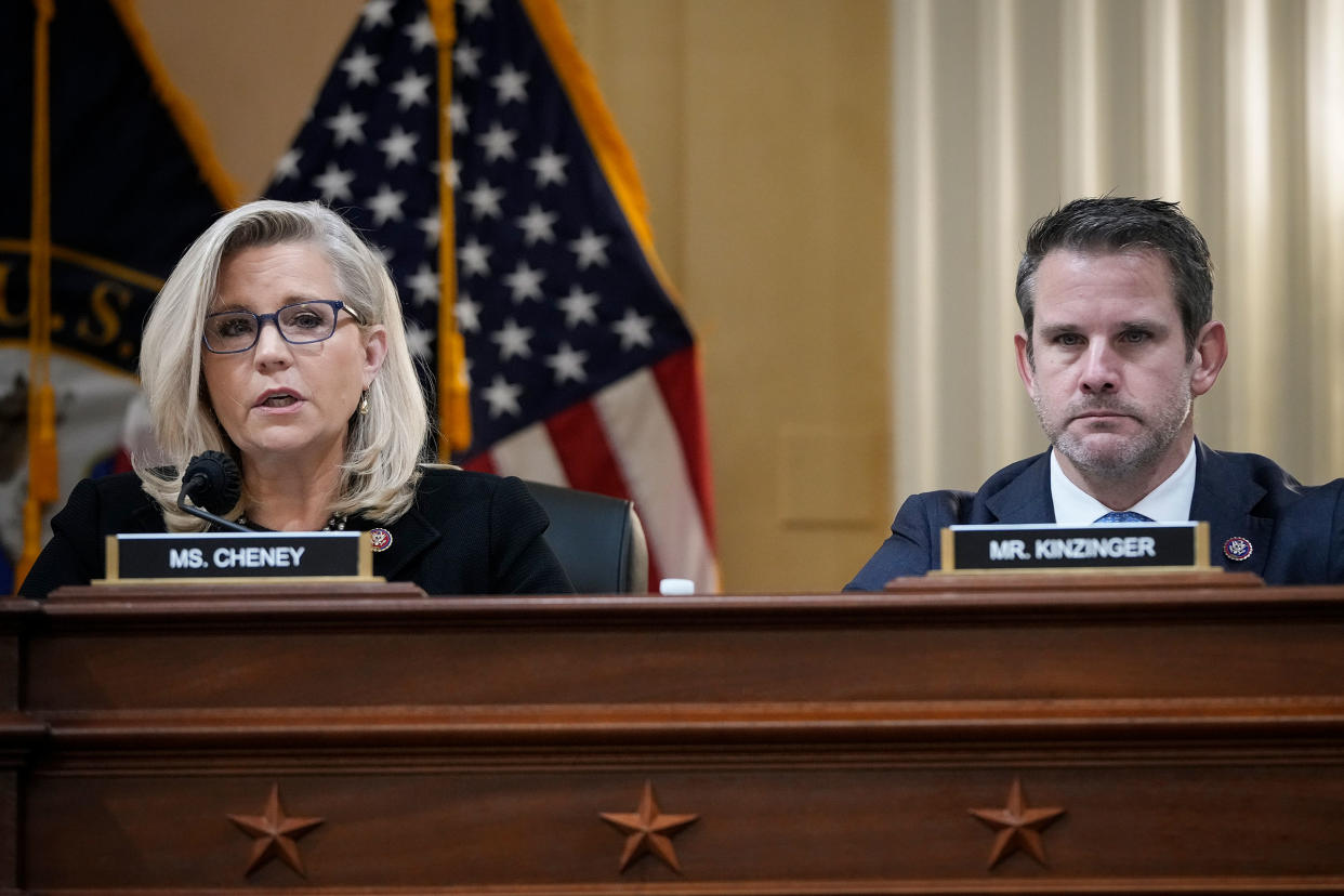 Rep. Liz Cheney and Rep. Adam Kinzinger listen during a committee meeting on Capitol Hill in Washington on Dec. 1, 2021.