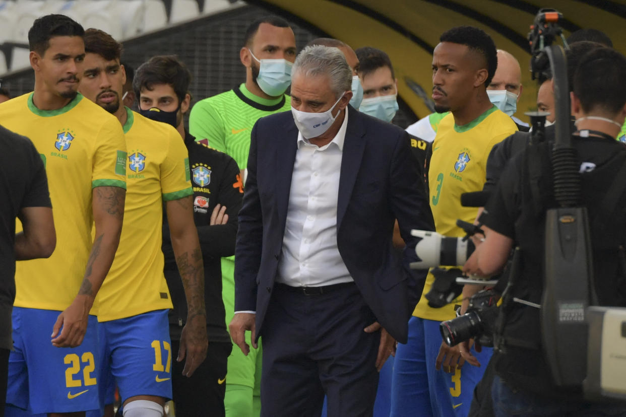 Brazil's coach Tite (C) is seen after employees of the National Health Surveillance Agency (Anvisa) entered to the field during the South American qualification football match for the FIFA World Cup Qatar 2022 between Brazil and Argentina.