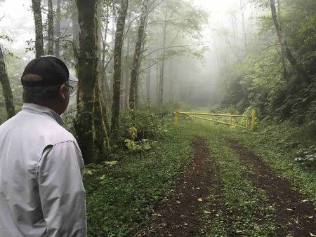 Avid hunter and angler Dean Finnerty, 52, of Scottsburg, Oregon, stares at a locked gate on a logging road through which for years he would hunt black bear and elk before the land was sold and he lost access inside the Elliott State Forest in southwest Oregon, U.S. on July 27, 2016. REUTERS/Eric Johnson