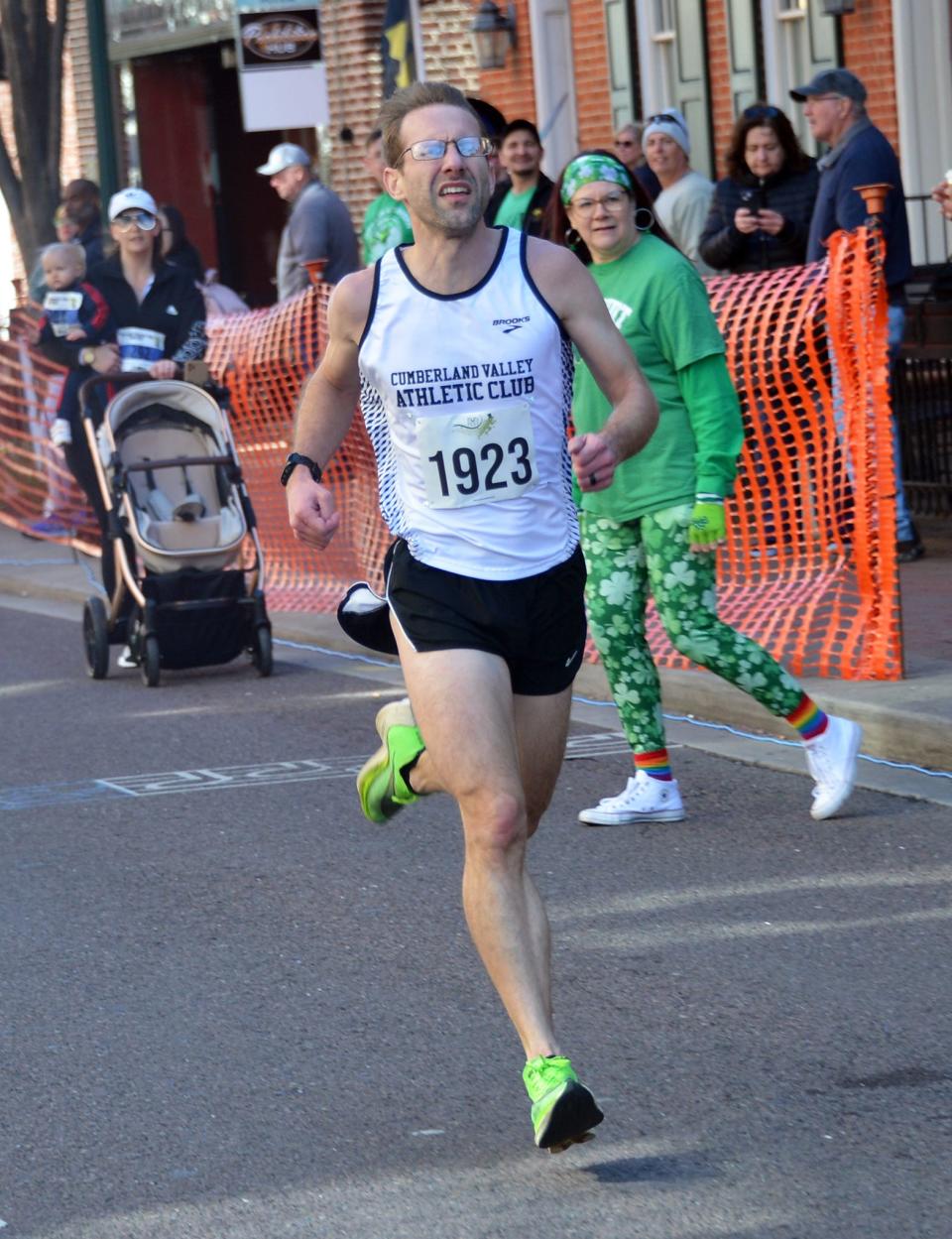 Dustin Adams, 34, a Clear Spring graduate now residing in Shippensburg, Pa., runs to the finish line to win the 2024 St. Patrick's Day Run Fest 5K.